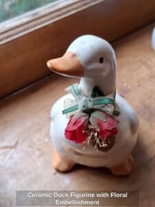 Ceramic-Duck-Figurine-with-Floral-Embellishment