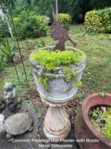 Concrete-Pedestal-Urn-Planter-with-Rustic-Metal-Silhouette