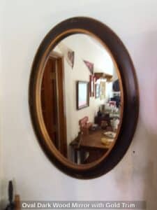 Oval-Dark-Wood-Mirror-with-Gold-Trim