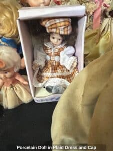 Porcelain-Doll-in-Plaid-Dress-and-Cap