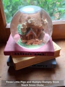 Three-Little-Pigs-and-Humpty-Dumpty-Book-Stack-Snow-Globe