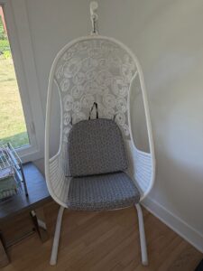 White-Wicker-Hanging-Chair-with-Geometric-Pattern-Cushions-and-Stand