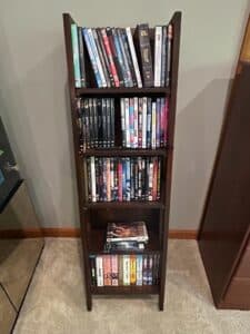 Assorted-DVD-Collection-on-Dark-Wood-Multi-Tiered-Shelf