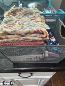 Assorted-Towels-and-Fabric-Items-in-Mesh-Basket