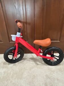 Red-Balance-Bike-with-White-Basket-and-Brown-Grips