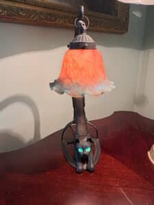 Vintage-Cast-Iron-Crouching-Cat-Lamp-with-Glowing-Green-Eyes-and-Iridescent-Glass-Shade-second-image