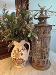 Antique-Brown-Transferware-Pitcher-with-Floral-and-Fish-Motif-and-Oriental-Style-Metal-Lantern