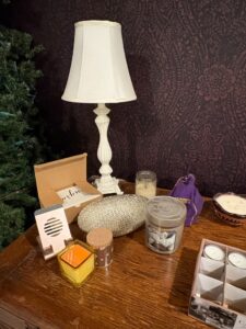 Assorted-Scented-Candles-and-White-Ornate-Table-Lamp
