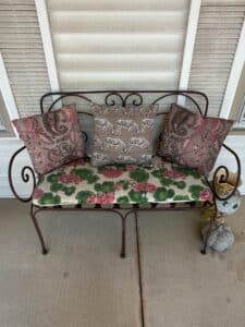 Vintage-Wrought-Iron-Garden-Bench-with-Floral-and-Zebra-Print-Cushions