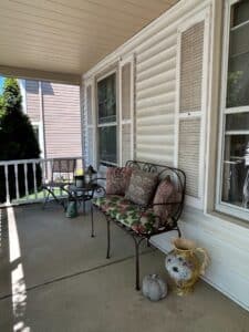 Wrought-Iron-Garden-Bench-with-Floral-Cushions
