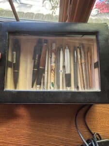 Collection-of-Assorted-Writing-Instruments-in-Display-Case
