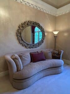 Curved-Upholstered-Sofa-with-Decorative-Oval-Mirror