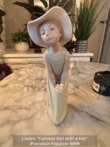 Lladro-Curious-Girl-with-a-Hat-Porcelain-Figurine