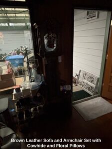 Brown-Leather-Sofa-and-Armchair-Set-with-Cowhide-and-Floral-Pillows