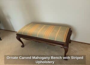 Ornate-Carved-Mahogany-Bench-with-Striped-Upholstery-second-image