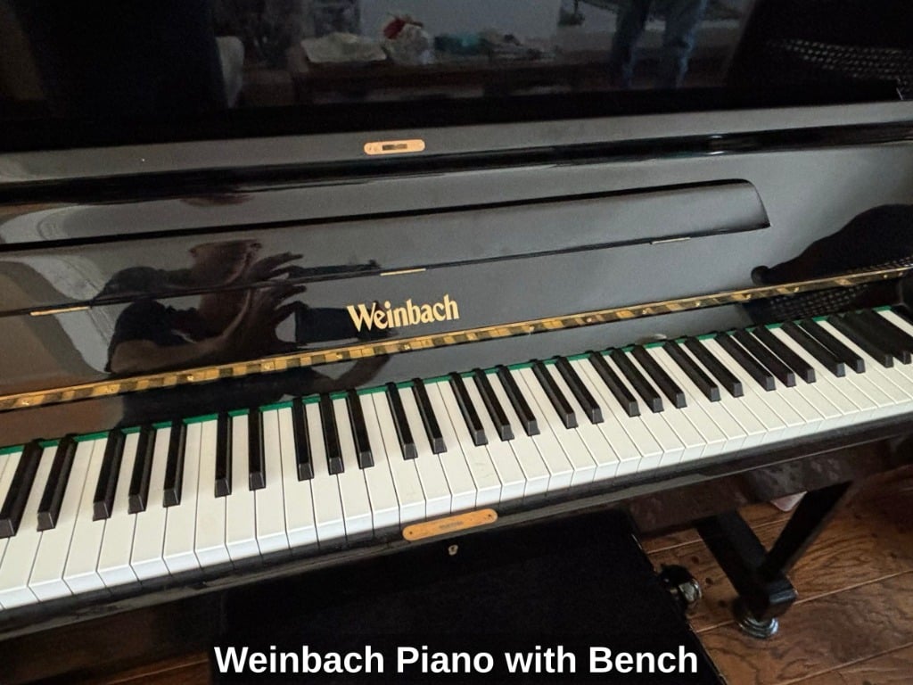 Weinbach upright piano in black high-gloss finish with matching bench, front view with lid closed, brass piano lamp on top, Foster City estate sale