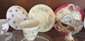 Assorted-Vintage-Porcelain-Teacups-and-Saucers-with-Floral-Motifs-fourth-image