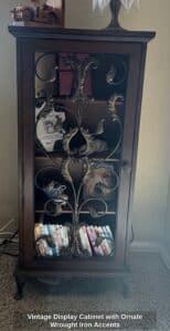 Vintage-Display-Cabinet-with-Ornate-Wrought-Iron-Accents