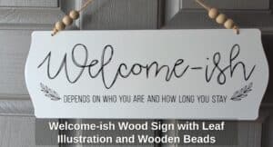 Welcome-ish-Wood-Sign-with-Leaf-Illustration-and-Wooden-Beads