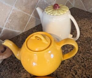 Yellow-Ceramic-Teapot-and-White-Ceramic-Teapot-with-Flower-Lid