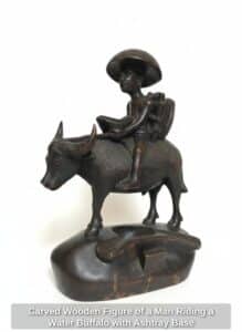 Carved-Wooden-Figure-of-a-Man-Riding-a-Water-Buffalo-with-Ashtray-Base