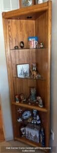 Oak-Corner-Curio-Cabinet-with-Decorative-Collectibles
