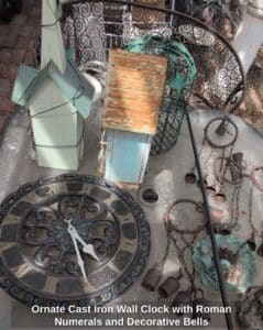 Ornate-Cast-Iron-Wall-Clock-with-Roman-Numerals-and-Decorative-Bells