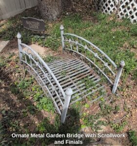 Ornate-Metal-Garden-Bridge-with-Scrollwork-and-Finials