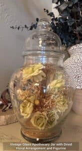 Vintage-Glass-Apothecary-Jar-with-Dried-Floral-Arrangement-and-Figurine