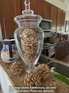 Large-Glass-Apothecary-Jar-with-Decorative-Pinecone-Spheres