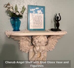 Cherub-Angel-Shelf-with-Blue-Glass-Vase-and-Figurines
