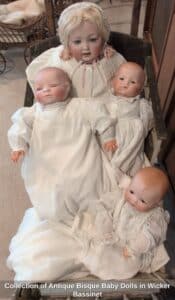 Collection-of-Antique-Bisque-Baby-Dolls-in-Wicker-Bassinet