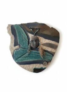 Handmade-Ceramic-Wall-Plaque-with-Face-and-Feather-Pendant