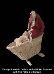 Vintage-Porcelain-Dolls-in-White-Wicker-Bassinet-with-Red-Polka-Dot-Canopy-second-image