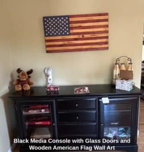 Black-Media-Console-with-Glass-Doors-and-Wooden-American-Flag-Wall-Art