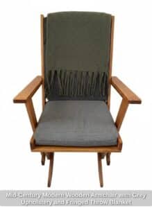 Mid-Century-Modern-Wooden-Armchair-with-Grey-Upholstery-and-Fringed-Throw-Blanket