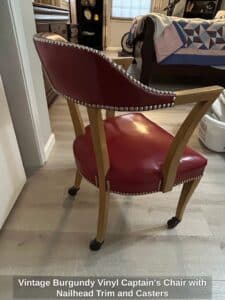 Vintage-Burgundy-Vinyl-Captains-Chair-with-Nailhead-Trim-and-Casters-fourth-image