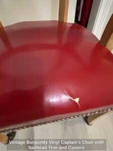Vintage-Burgundy-Vinyl-Captains-Chair-with-Nailhead-Trim-and-Casters-second-image