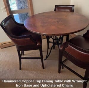 Hammered-Copper-Top-Dining-Table-with-Wrought-Iron-Base-and-Upholstered-Chairs