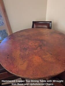 Hammered-Copper-Top-Dining-Table-with-Wrought-Iron-Base-and-Upholstered-Chairs-second-image
