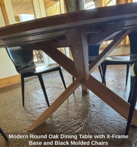 Modern-Round-Oak-Dining-Table-with-X-Frame-Base-and-Black-Molded-Chairs-third-image