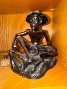 Carved-Wooden-Figure-of-a-Seated-Man-with-a-Hat-and-Waterfowl-Base