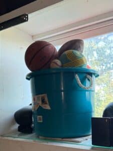 Collection-of-Sports-Balls-in-Teal-Bucket-with-NBA-Basketball