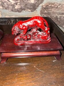 Red-Lacquered-Tiger-Figurine-on-Wooden-Stand