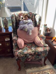 Vintage-Floral-Upholstered-Wingback-Chair-with-Doll-and-Footstool