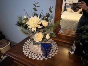 Artificial-Winter-Floral-Arrangement-with-Cobalt-Blue-Geometric-Vase-and-Crocheted-Doily