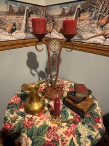 Brass-Pitcher-and-Ornate-Tassel-Candelabra-with-Faux-Books
