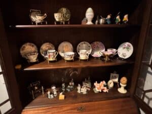 Collection-of-Porcelain-Teacups-and-Saucers-with-Decorative-Plates-and-Figurines