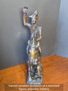 Carved-wooden-sculpture-of-a-mounted-figure-possibly-military