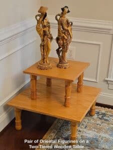 Pair-of-Oriental-Figurines-on-a-Two-Tiered-Wooden-Table-Copy